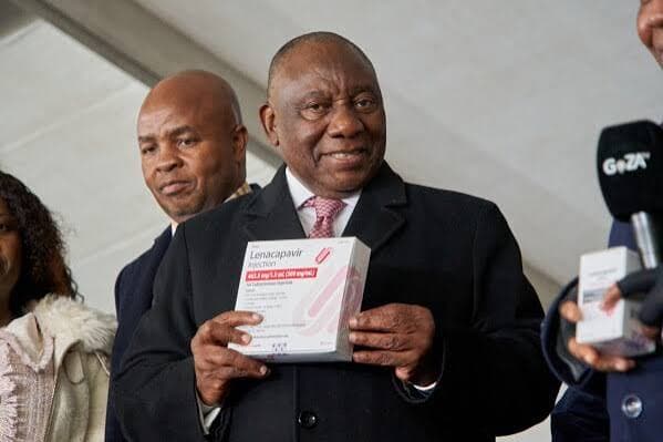 South African President Cyril Ramaphosa holds a box of lenacapavir during his country’s official launch of the drug. (AP Photo/Kayleen Morgan)